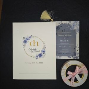 A sophisticated floral wedding invitation featuring a gold monogram wreath cover, layered translucent vellum overlay, multi-insert fan-style layout, and elegant tassel binding. Perfect for modern, classy wedding celebrations.